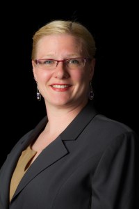 Headshot of Crystal in grey suit in 2015