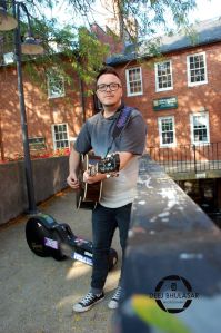 Picture of Ro Colegrove playing his guitar outdoors, taken by Deej Bhulasar